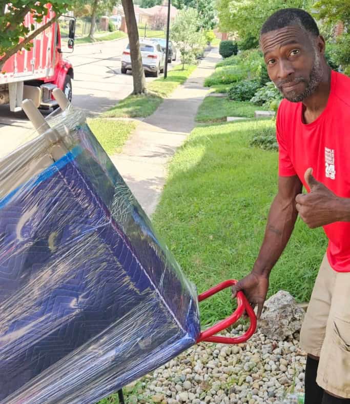 Man installing solar panel on a residential lawn, promoting renewable energy solutions.