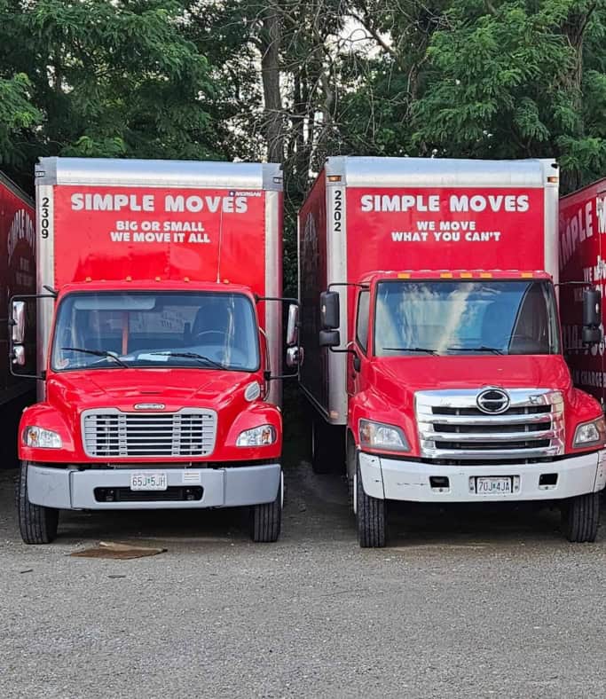 Two red moving trucks with 