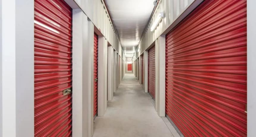 Storage unit hallway with red roll-up doors, ideal for simple moves and organized self-storage.